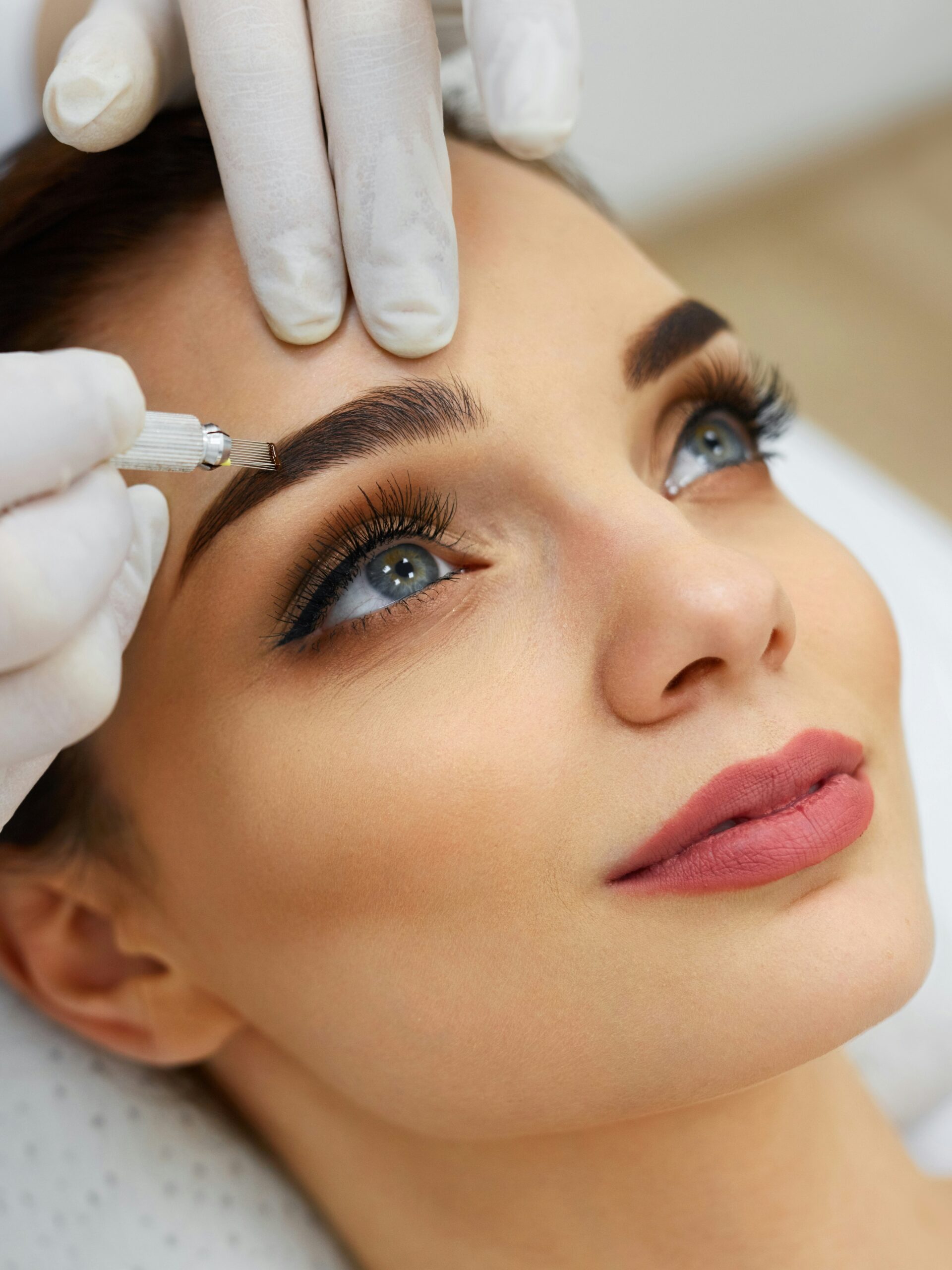 Primo piano del viso di una donna in un centro estetico durante un trattamento di microblading